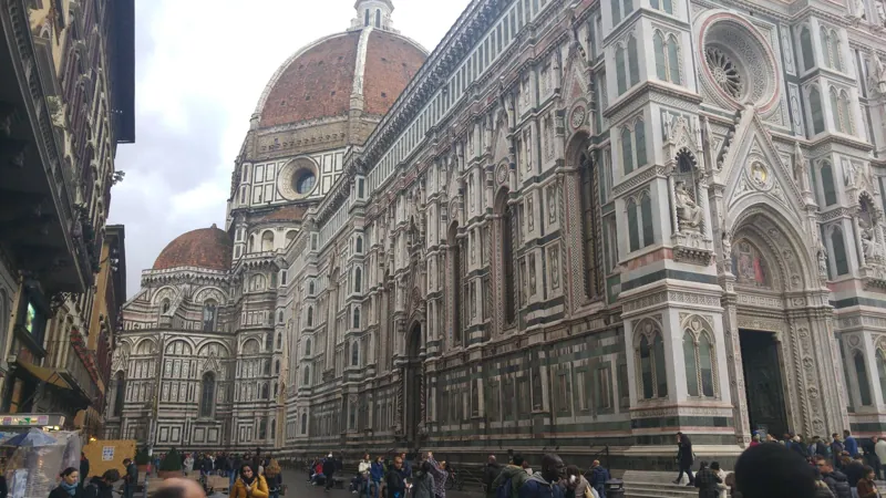 The marble facade and dome of Florence Cathedral from the street