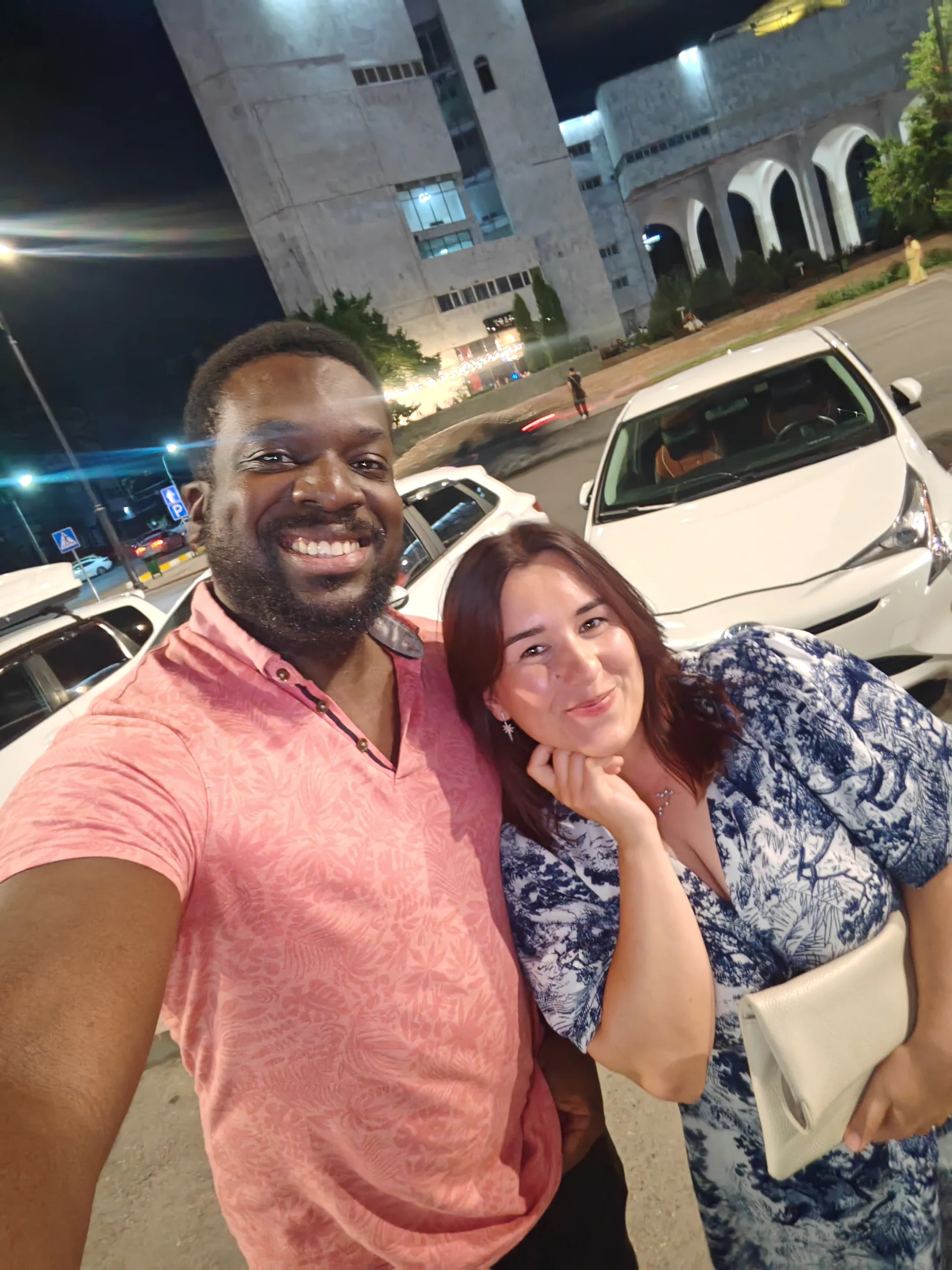 Two travellers together on a Bishkek street at night