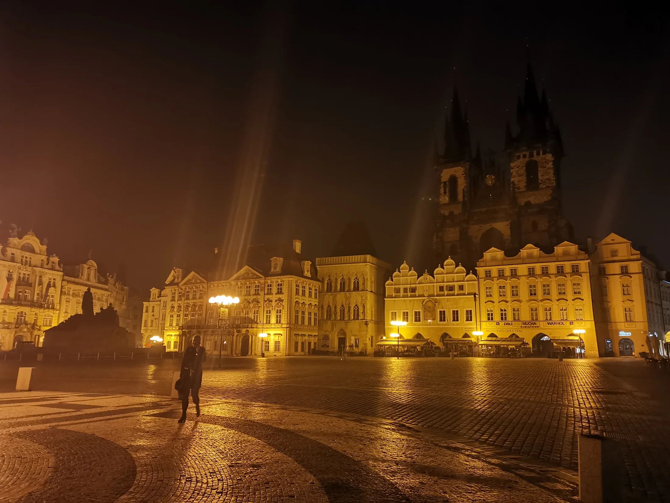 An illuminated Prague square on a quiet evening