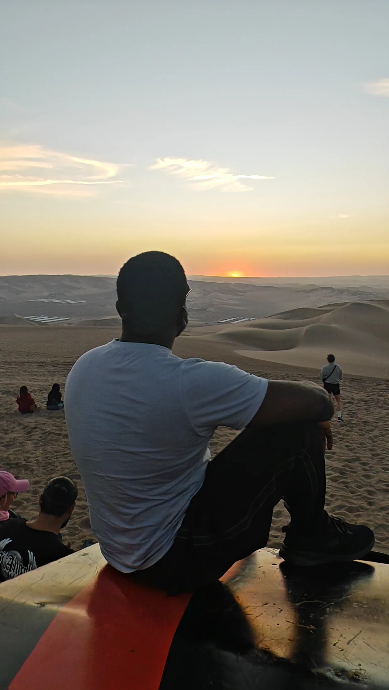 A traveller looking across the dunes in the evening