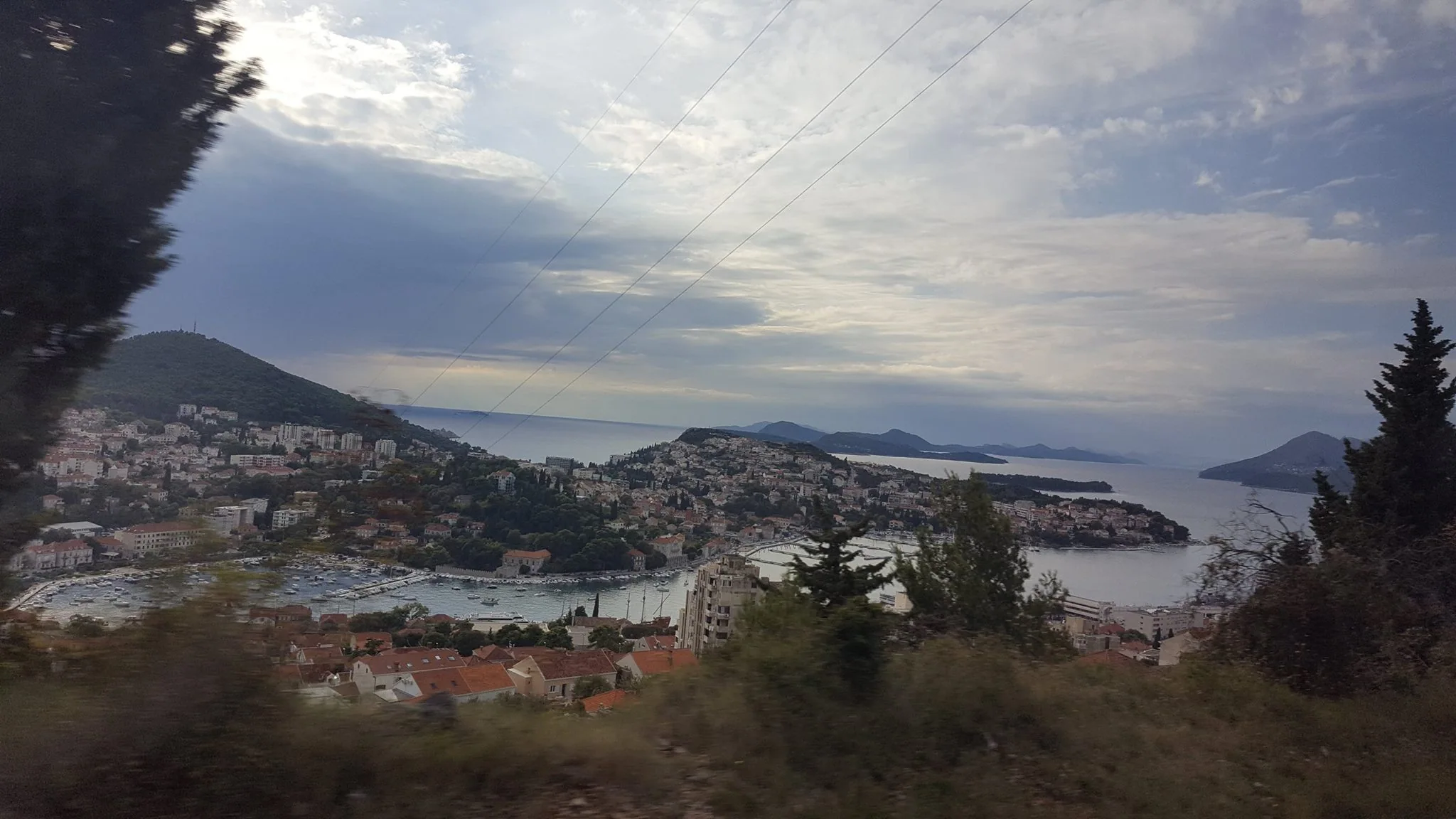 An elevated view across a Croatian harbour and surrounding hills