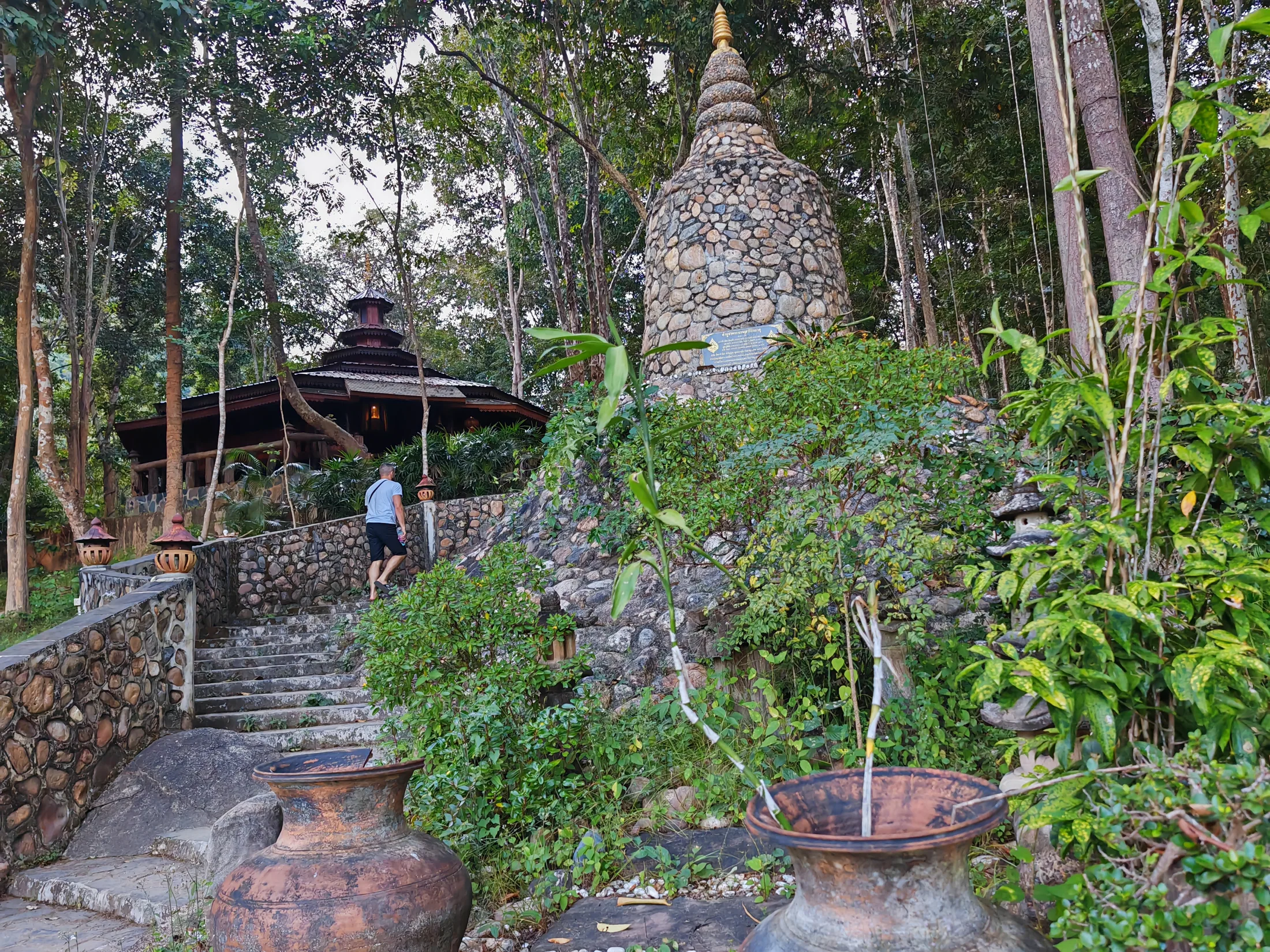 Stone steps and a small pagoda in a forest garden in northern Thailand