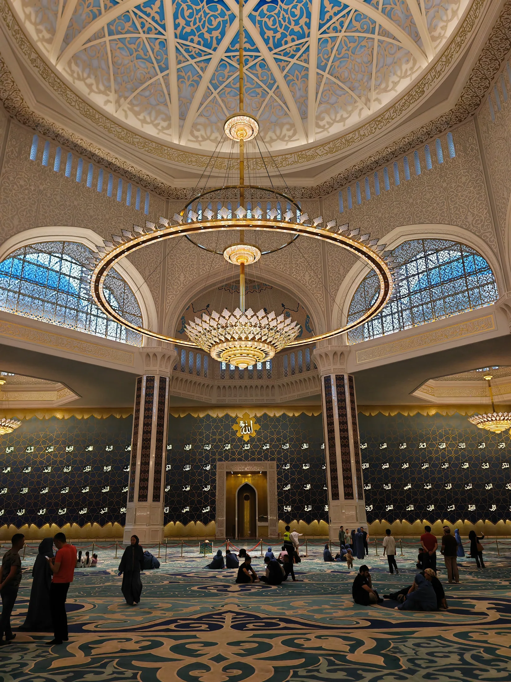 Chandeliers and patterned arches inside a mosque in Astana