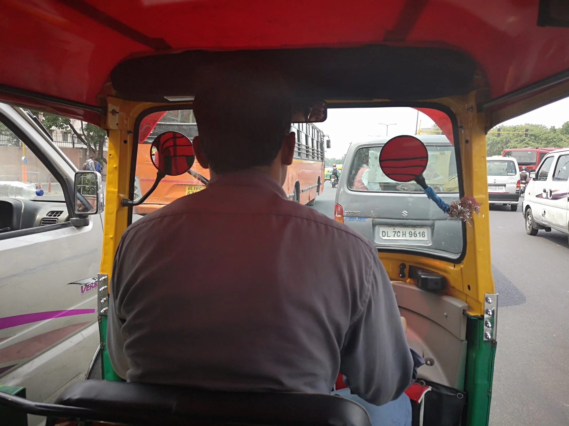 A street view from the back of an auto-rickshaw