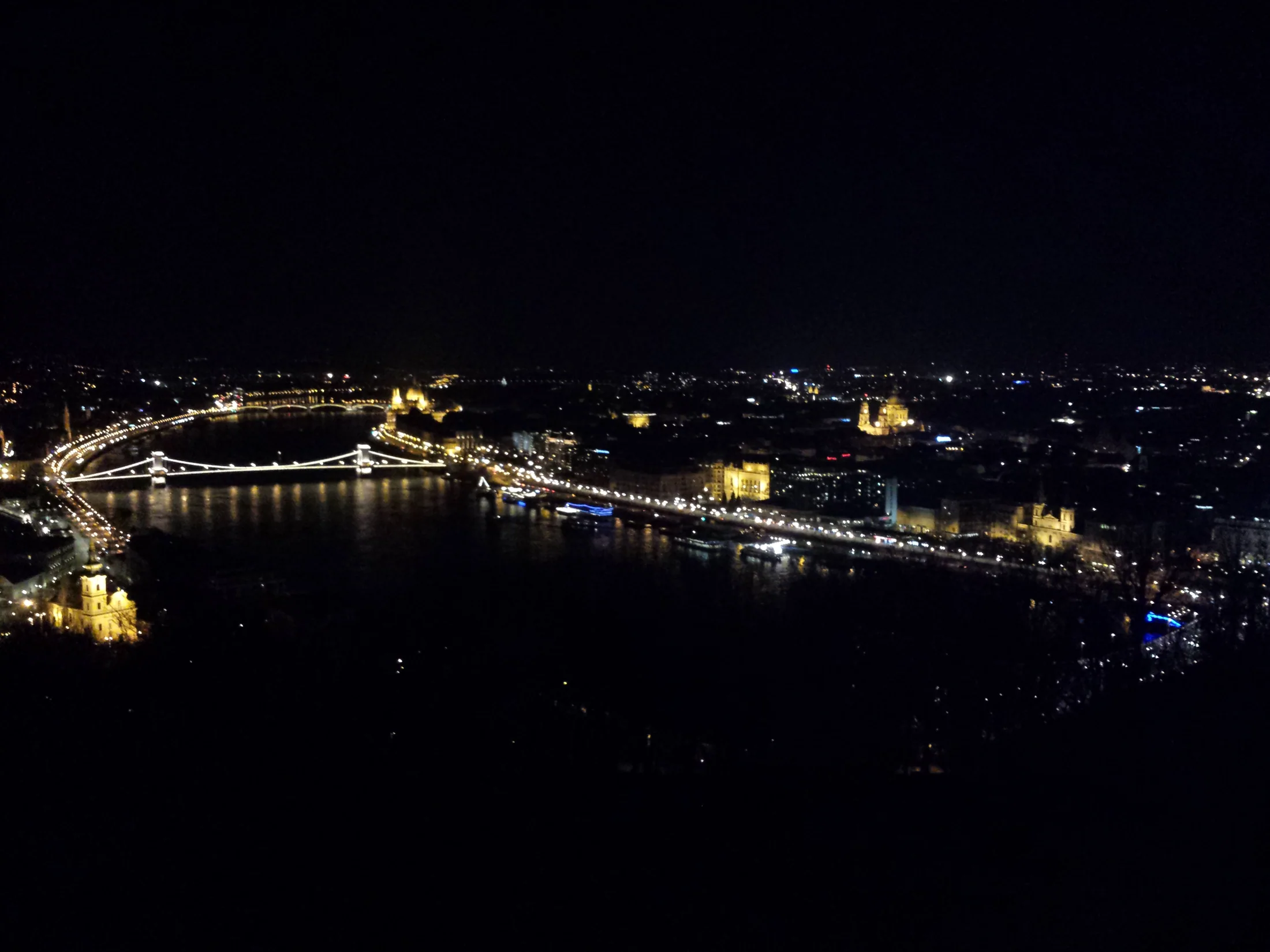 Illuminated bridges and buildings beside the Danube at night