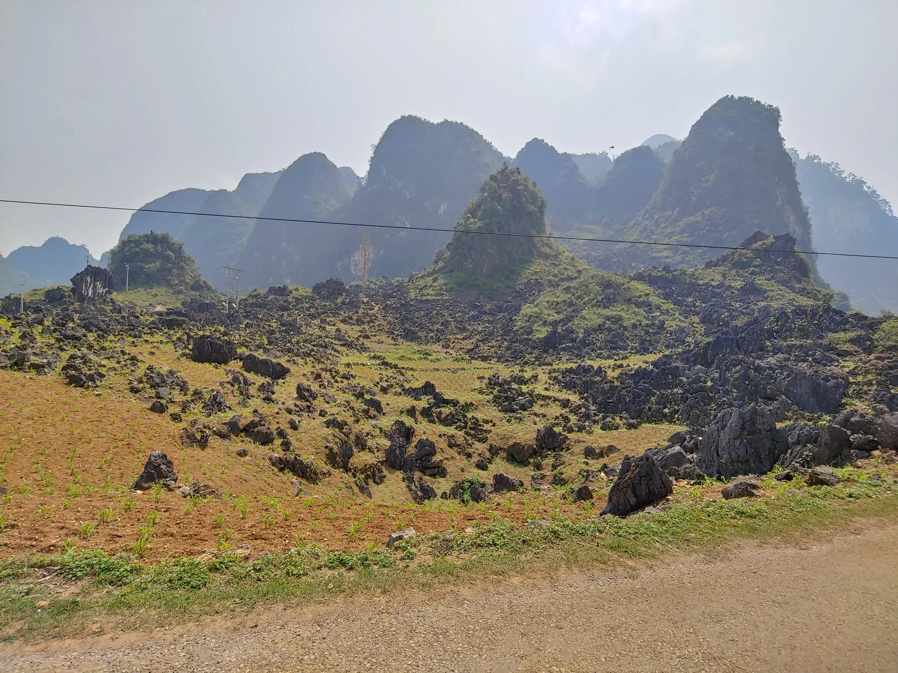 Sunlit karst peaks above a rocky green valley
